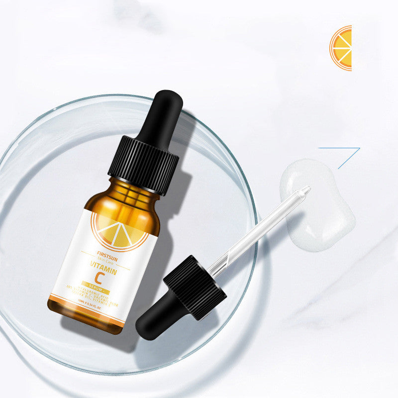 Vitamin C essence bottle with dropper for skin care and whitening.