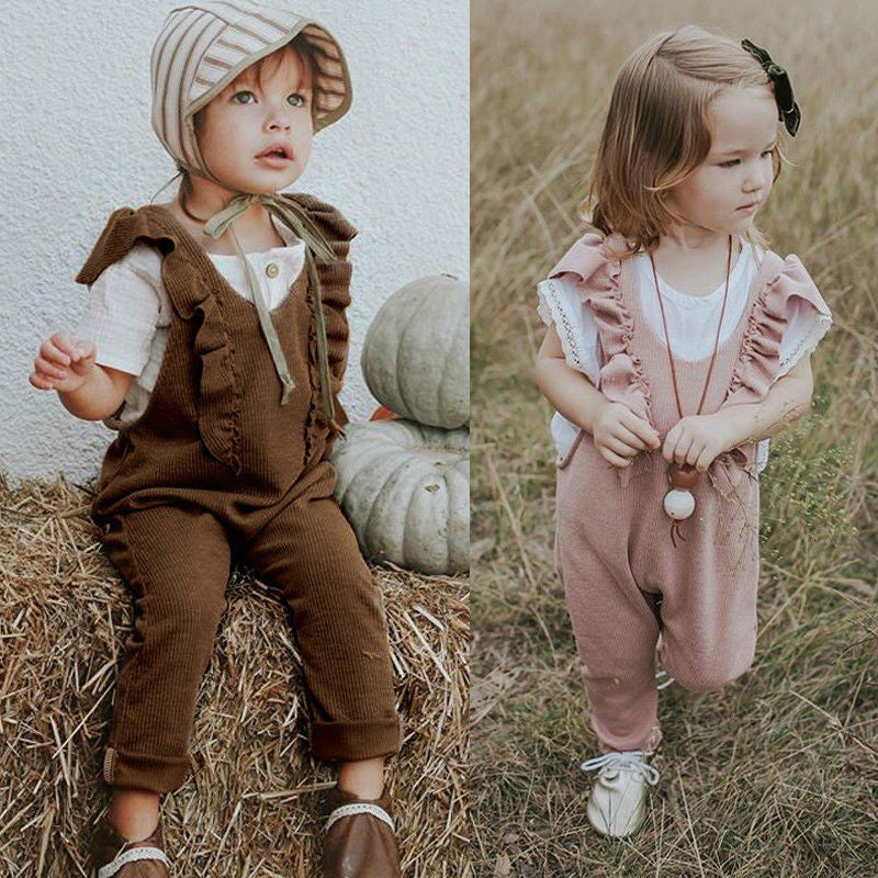 Baby girl in a knitted ruffle jumpsuit, long sleeve romper, brown and pink options available.