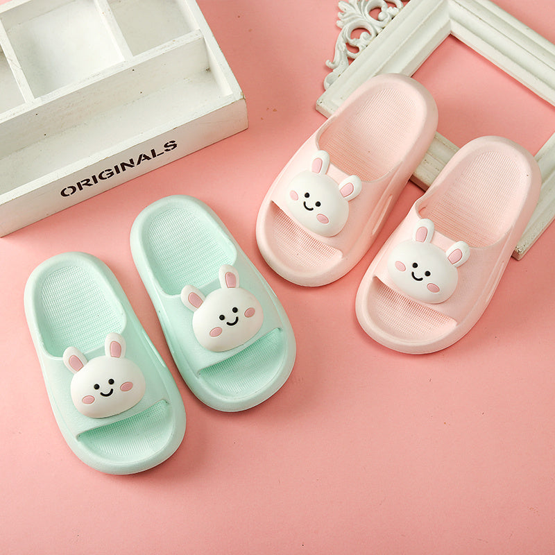 Kids' cartoon cute sandals with bunny design in pink and mint green, featuring flat PVC soles.