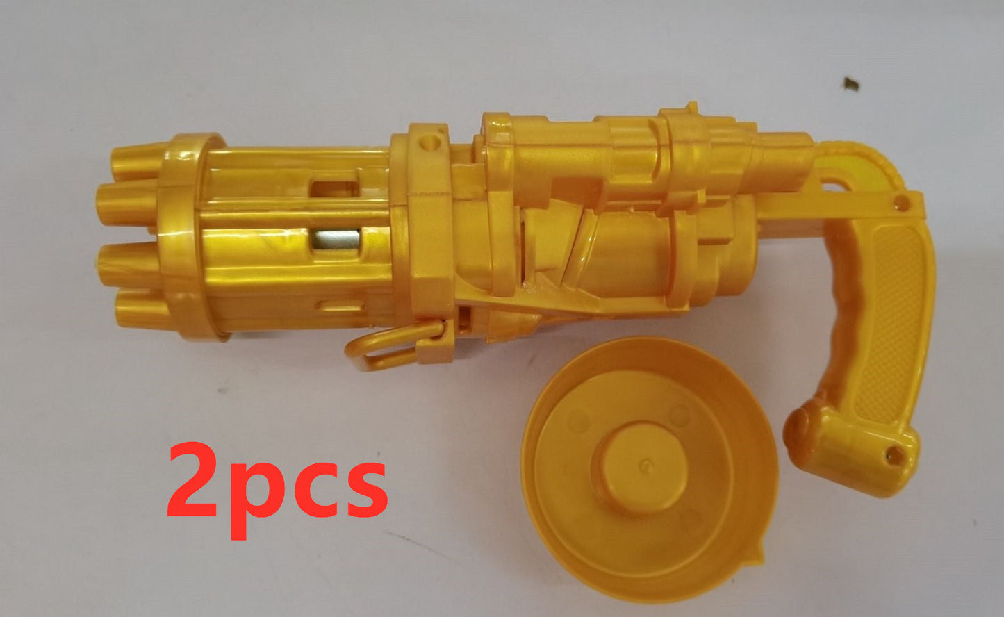 Yellow plastic bubble gum machine toy gun with detachable bubble head, 2 pieces shown.