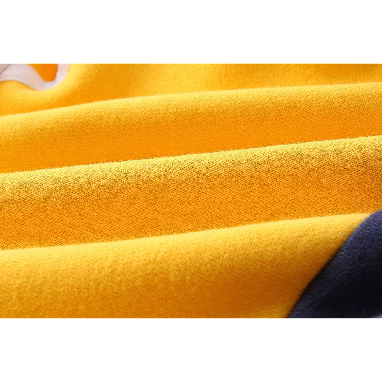 Close-up of yellow cotton fabric from a kids' baseball uniform jacket.