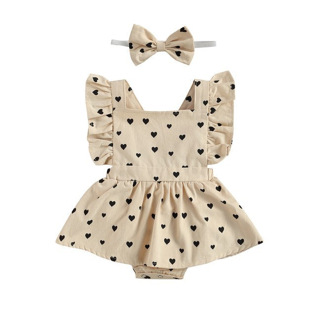 Girls beige dress with heart pattern and bow for holidays.