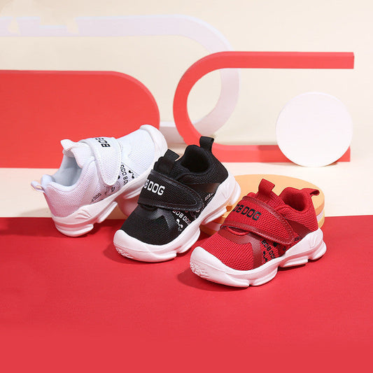 Toddler sneakers in white, black, and red with Velcro straps and breathable mesh design.