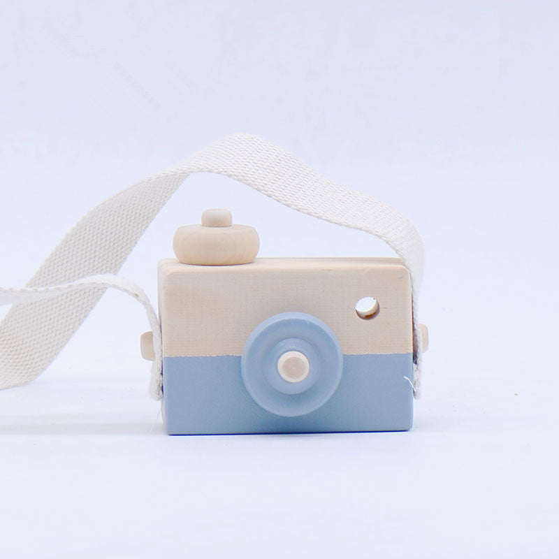 Cute wooden toy camera for kids, suitable for ages 3 and up.