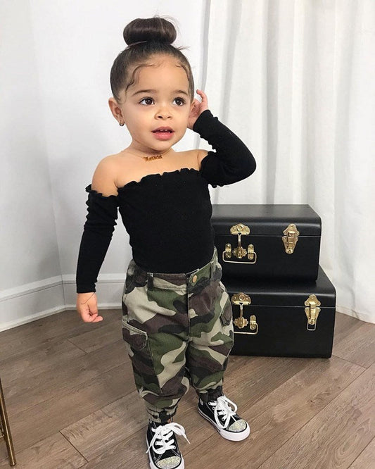 Toddler girl in black camouflage print top and pants set with long sleeves.