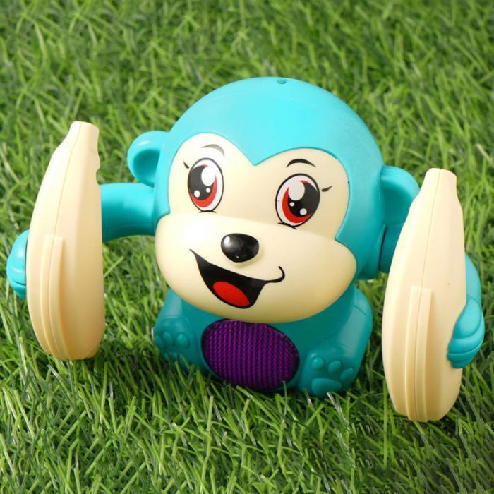 Light-up tumbling monkey toy on grass, blue color, educational gift for children.