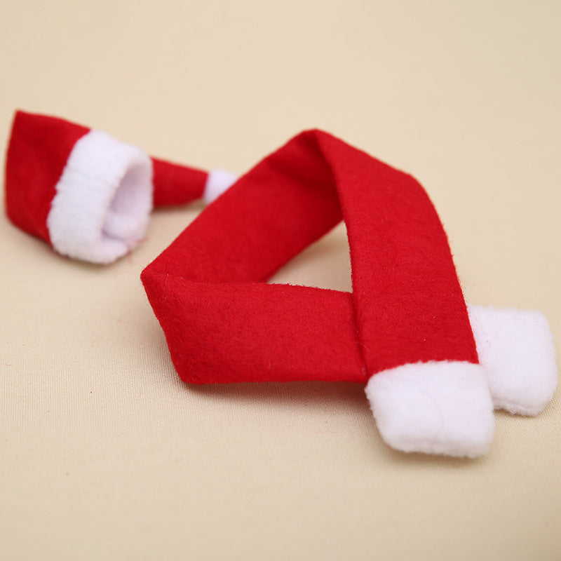 Red non-woven fabric Christmas scarf and hat set on beige background.