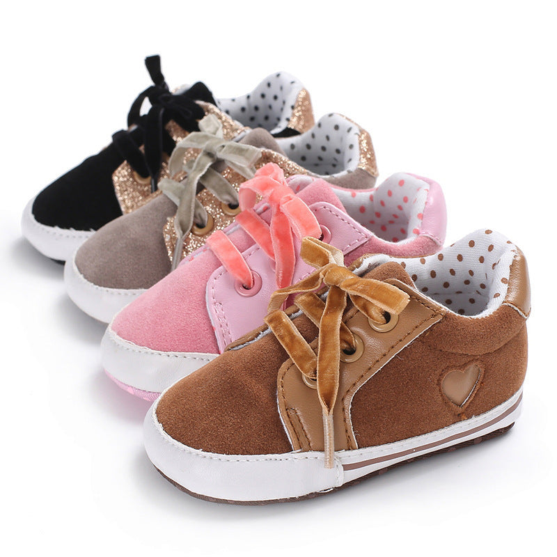 Colorful baby sneakers in brown, gray, pink, and black with cotton uppers, low top design, and non-slip soles for toddlers.