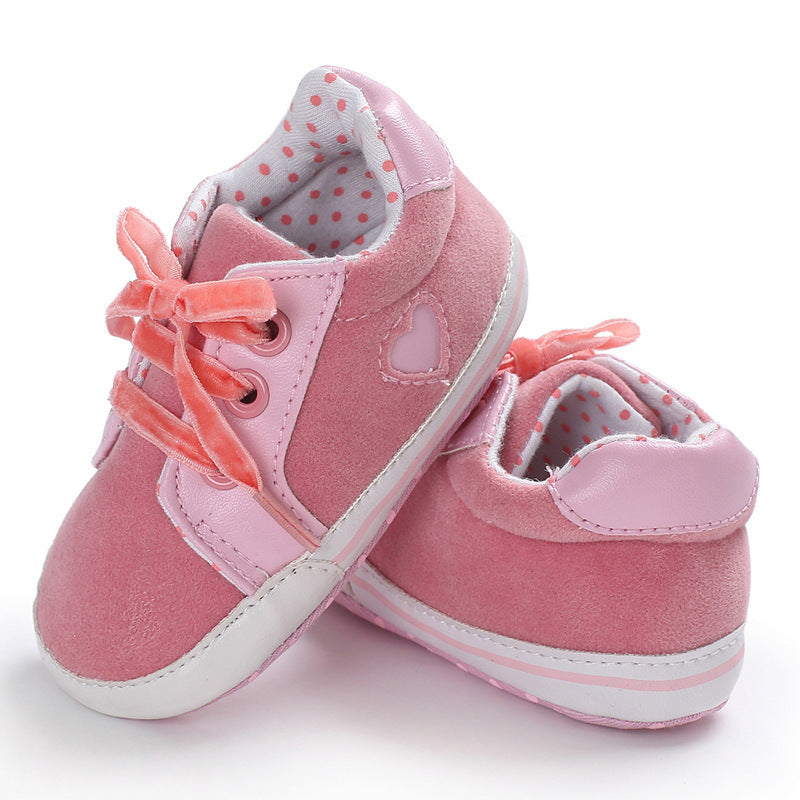 Pink baby sneakers, non-slip, casual style for toddlers, low top design with cotton cloth material.