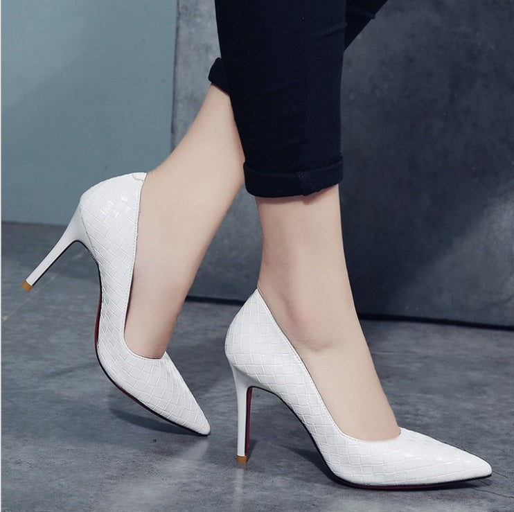 White high heels with pointed toe and striped pattern for women.