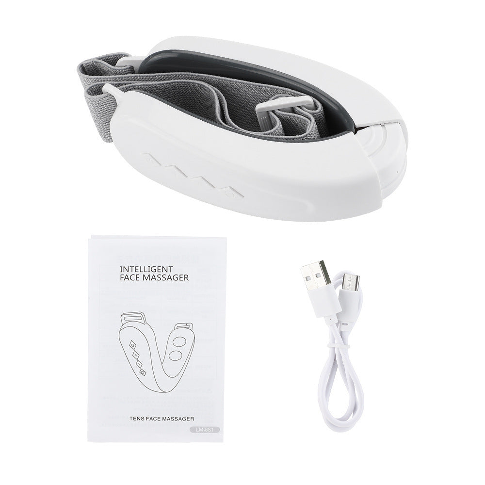 Micro-current facial massager with USB charging cable and manual.
