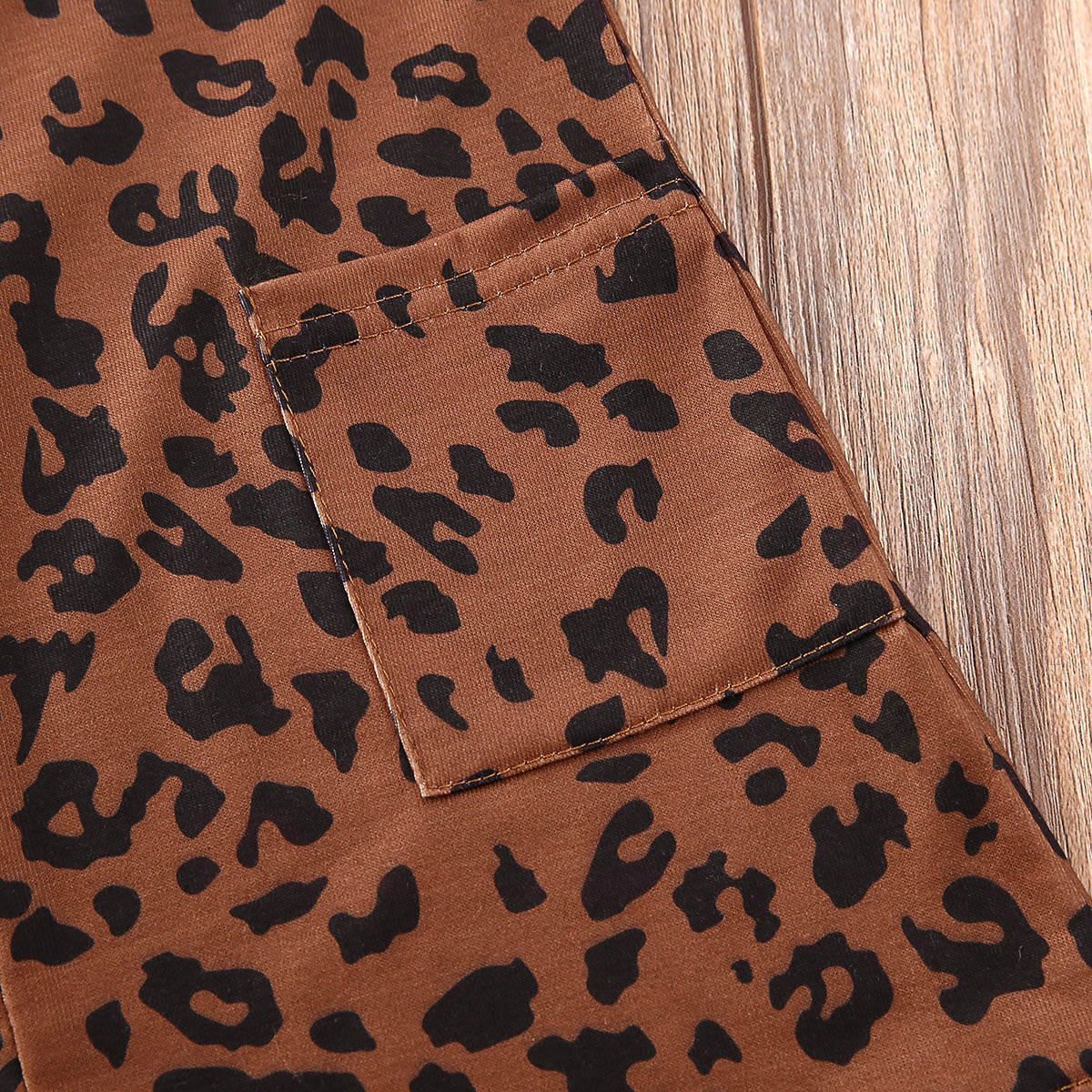 Leopard print fabric detail of a baby girl's sleeveless dress, made of 100% cotton.