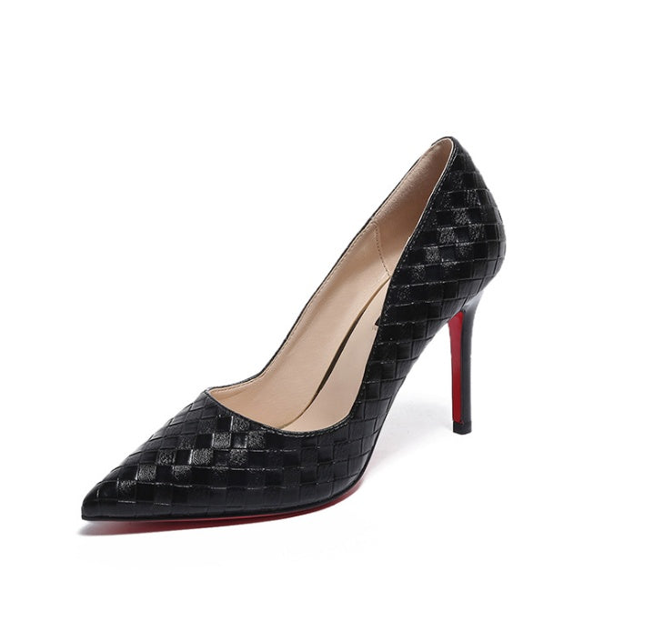 Black high heel with stripes, pointed toe, and floral elements.