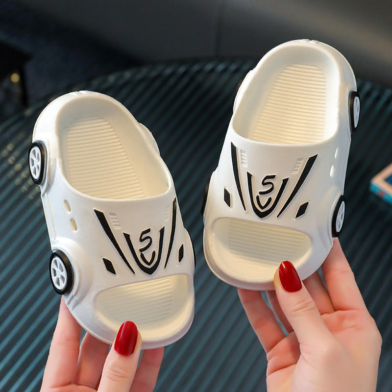 Cartoon kid baby slippers with car design in neutral colors.