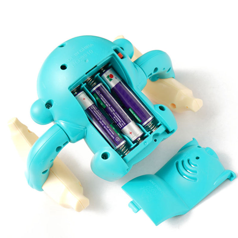 Light-Up Tumbling Monkey Toy with battery compartment open, suitable for children age 3 and up.