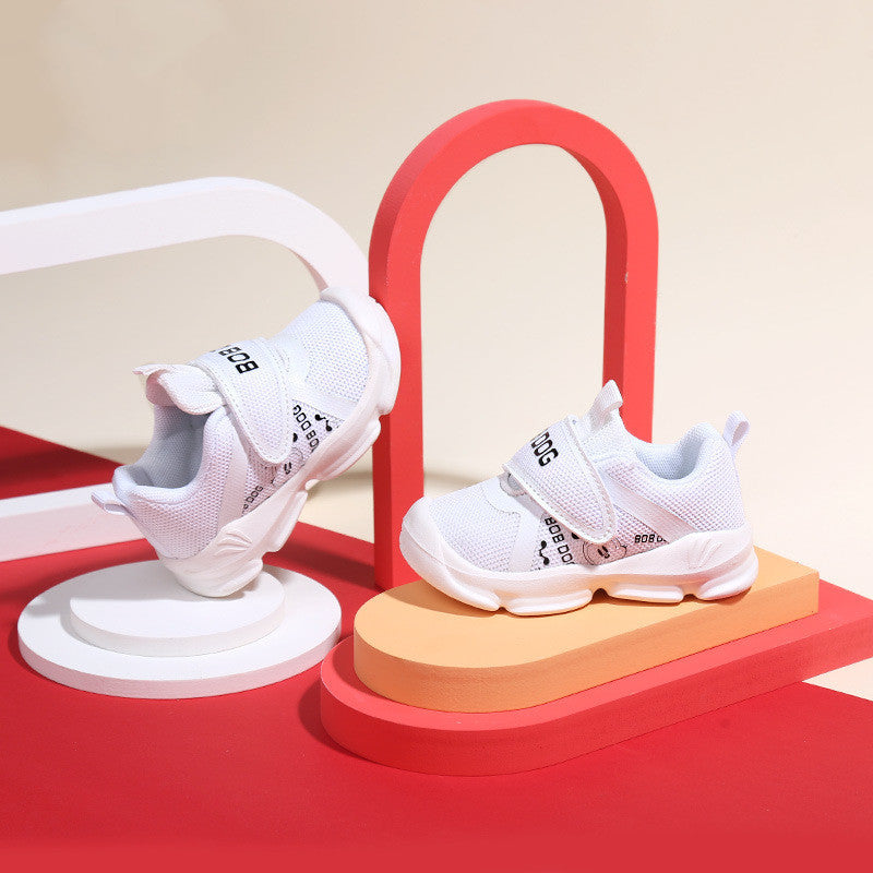 White toddler sneakers with breathable mesh, cowhide accents, and Velcro closure.