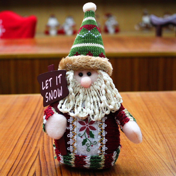 Flannel Christmas snowman decoration in red, green, and white holding a "Let it Snow" sign, size 18x13cm.