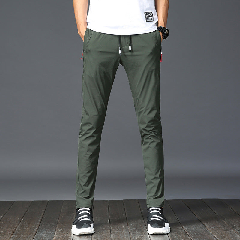 Mens Thick Stretch Trousers in Green on a model wearing a white T-shirt, front view showing the tapered silhouette