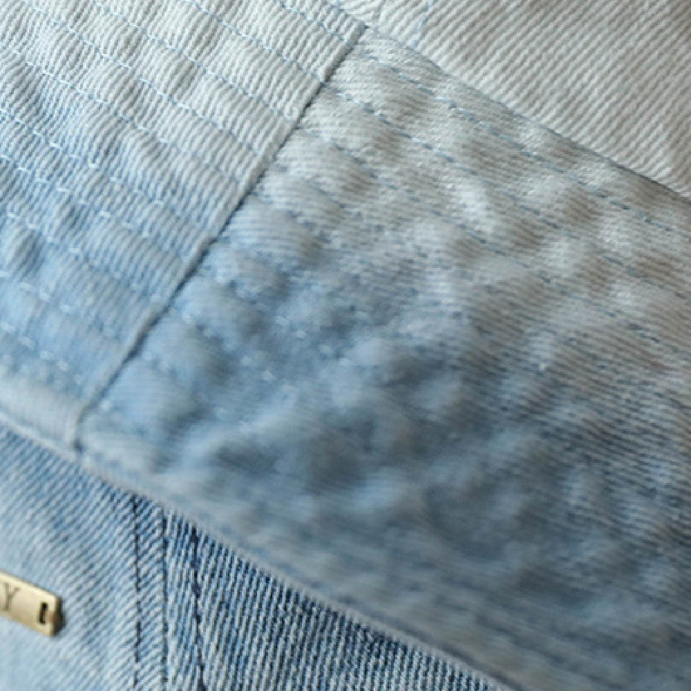 Vintage Washed Bucket Hat close-up showing the faded blue fabric texture and parallel rows of brim stitching.