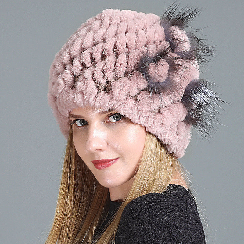 Womens Fur Knitted Hat in dusty pink with textured rows and a matching decorative side flower.