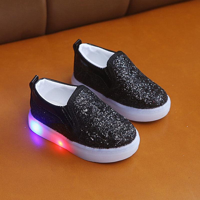Kids LED sneakers with sequins in black, featuring colorful light-up soles.