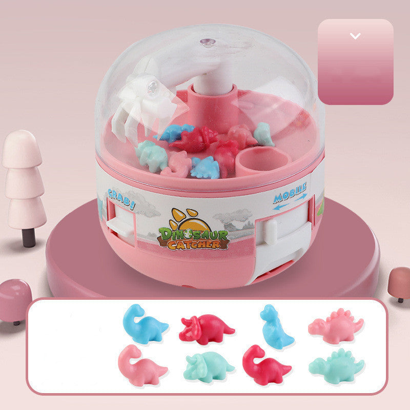 Children's mini dinosaur gashapon toy grabbing machine in pink with colorful dinosaur figures.