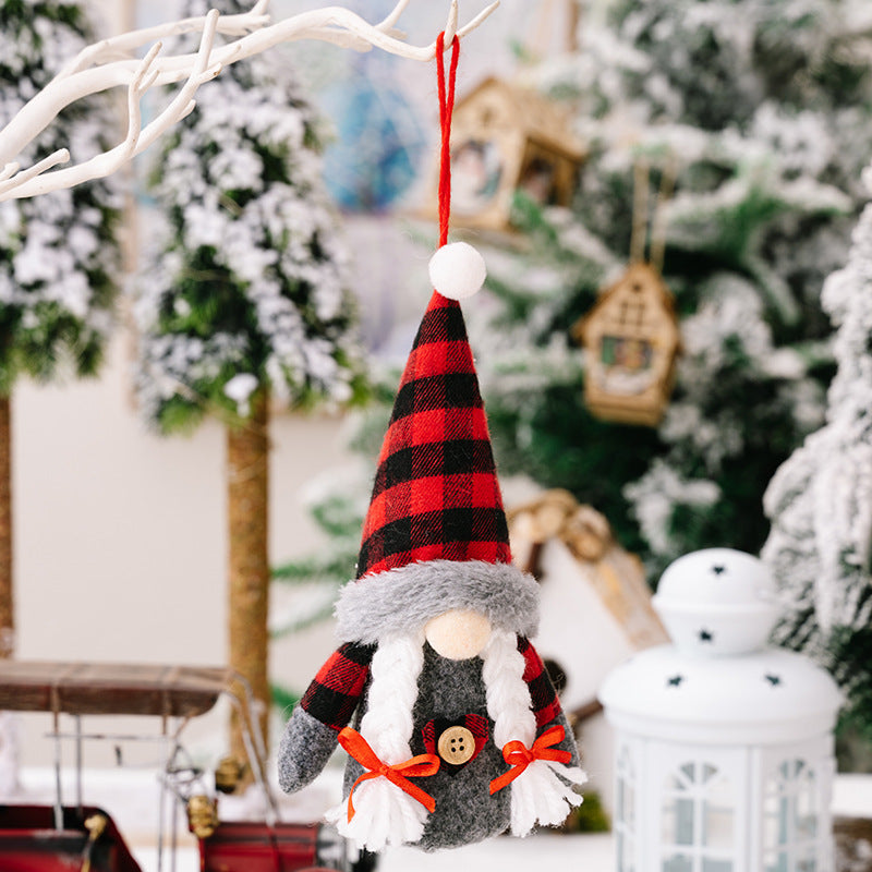 Christmas decoration faceless doll ornament with red and black plaid design.