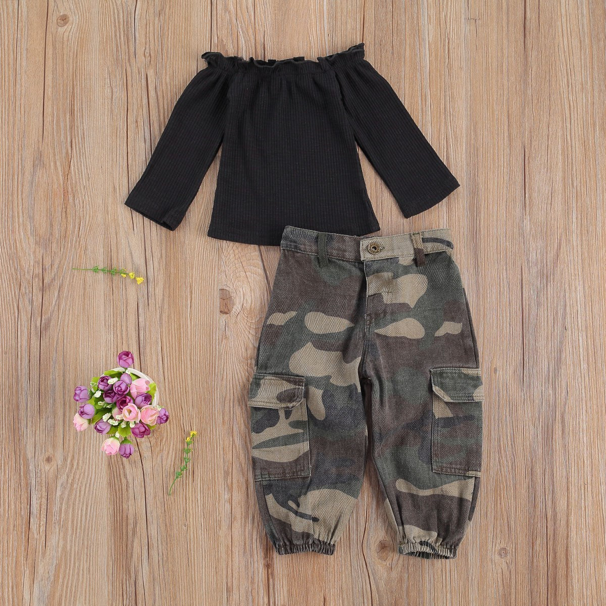 Girls' summer outfit with black ribbed off-shoulder top and camouflage print pants.