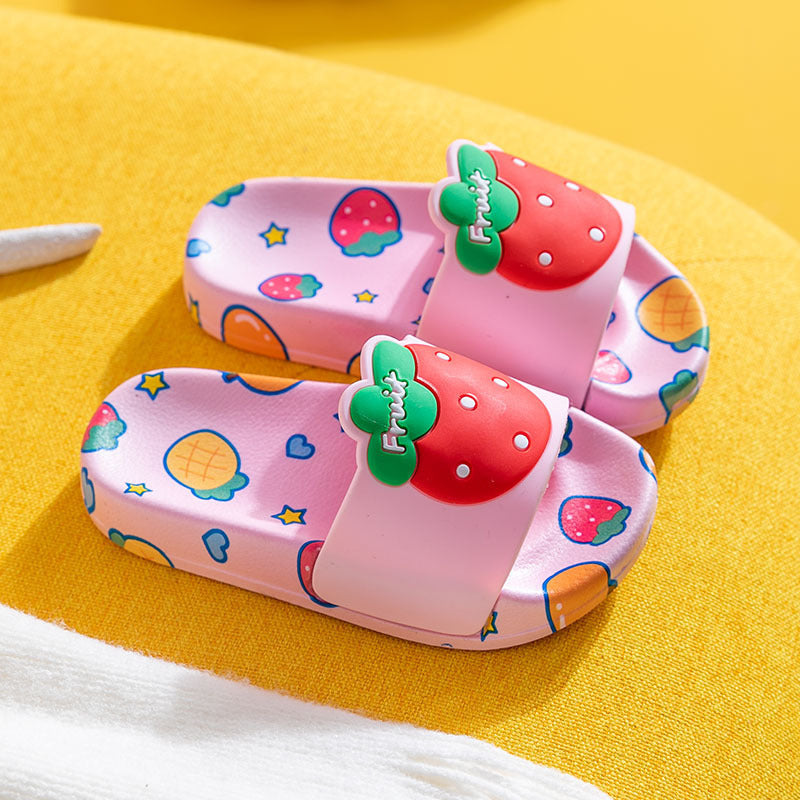 Pink strawberry-themed children's slippers with cartoon pattern and non-slip PVC sole.
