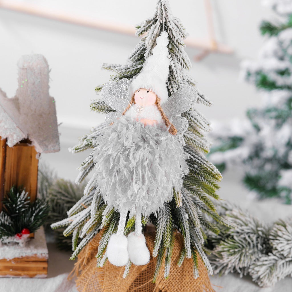 Christmas angel decoration on snowy tree, gray cloth material, creative window display.