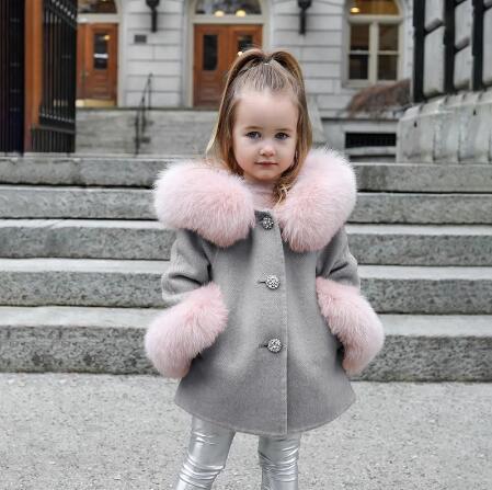 Kids pink fur-trimmed woolen coat for girls, winter fashion.