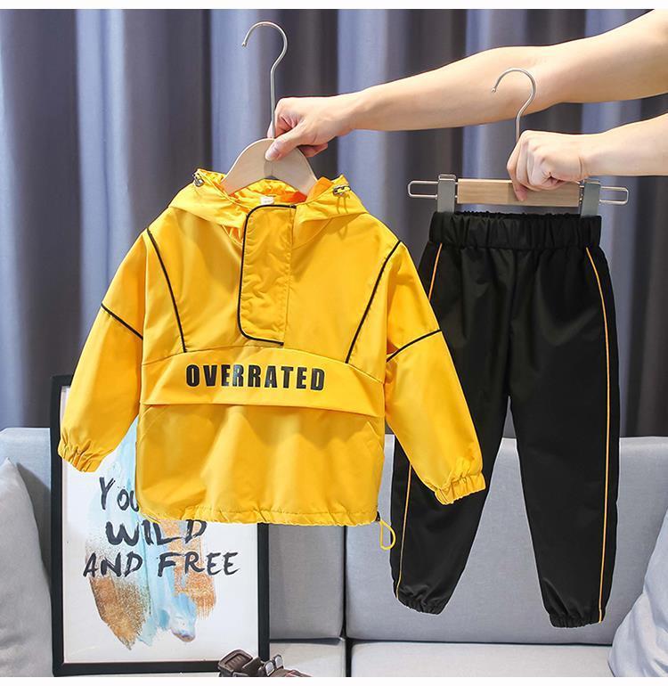 Trendy kid's yellow and black two-piece suit with "OVER RATED" print, featuring a stylish cotton jacket and pants.