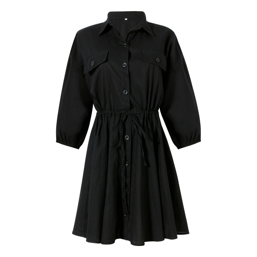 Black casual dress with button-down front and cinched waist design.