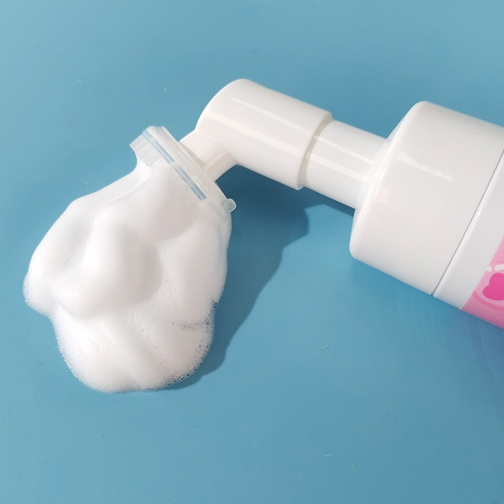 Herbal deep cleansing foaming facial wash bottle with foamy mousse on blue background.
