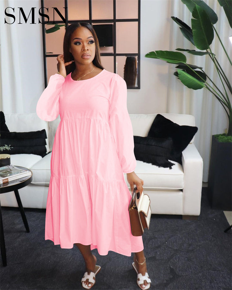 Plus size pink casual dress with long sleeves for women in a trendy, solid color design.