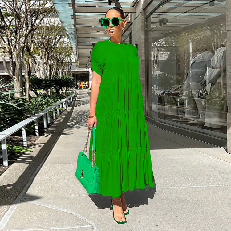 Autumn 2023 women's green loose-fit short sleeve casual dress in urban setting.