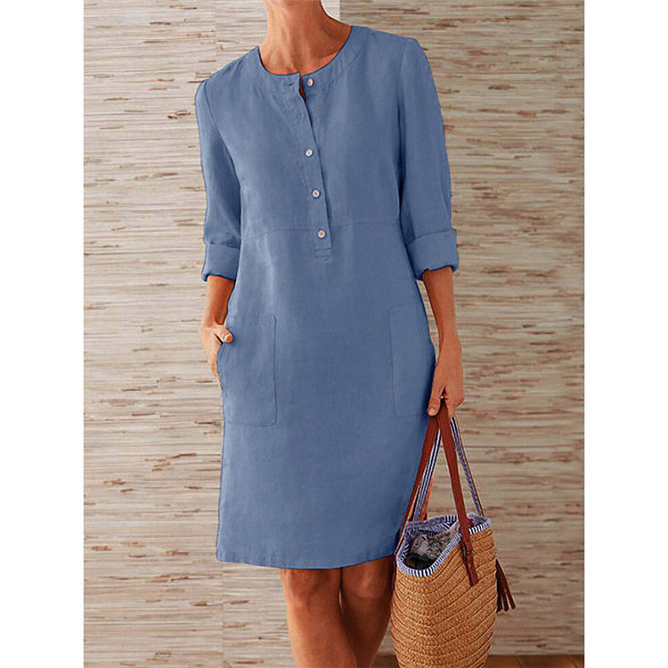 Elegant simple cotton summer dress for women in sky blue, shown with half sleeve design and button details, styled with a woven tote bag.