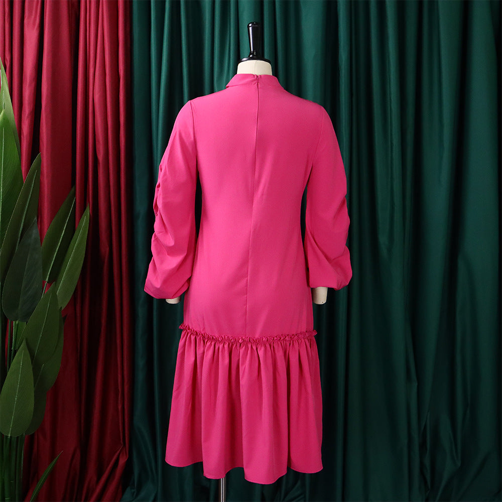 Elegant pink knee-length dress with long sleeves, perfect for casual or formal occasions.