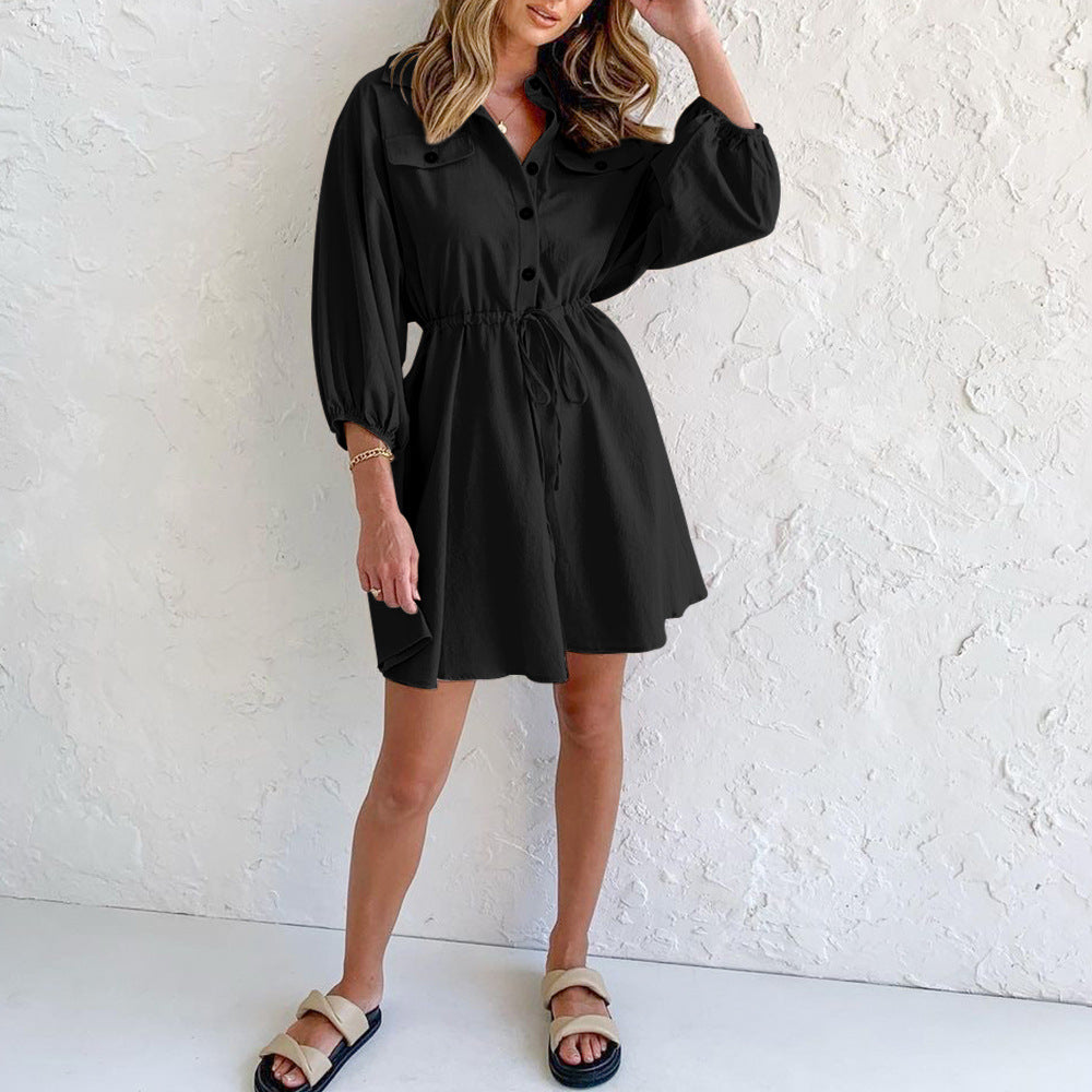 Women's casual black dress with button front, long sleeves, and a drawstring waist.