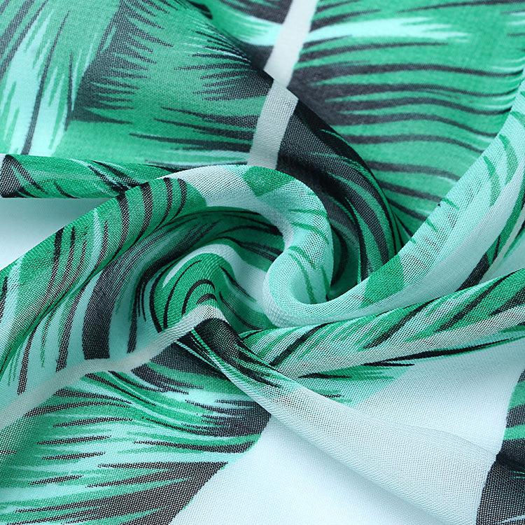 Palm print chiffon fabric detail of a beach kimono cover up dress.