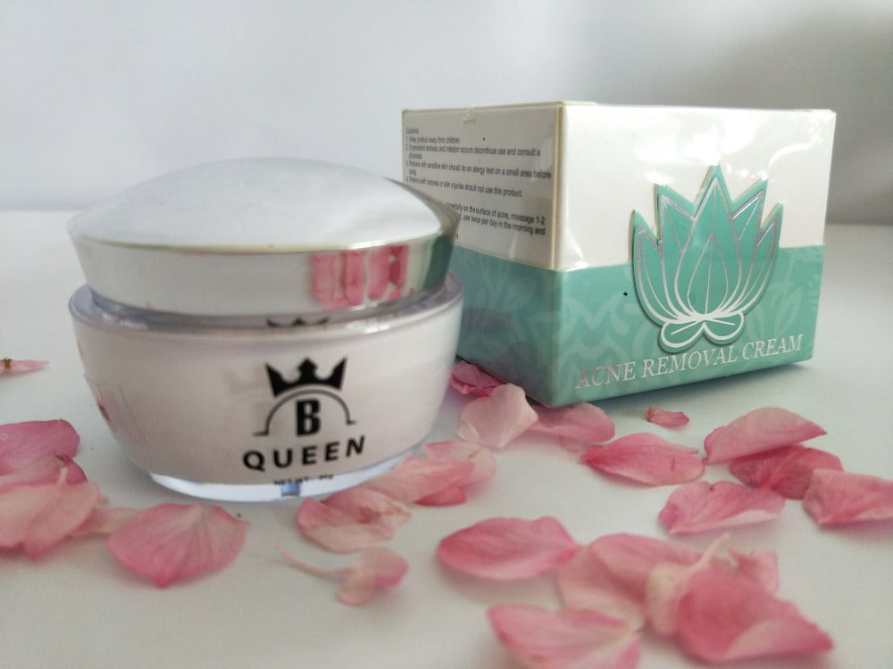 B-Queen Acne Removal Cream jar and box surrounded by pink petals.