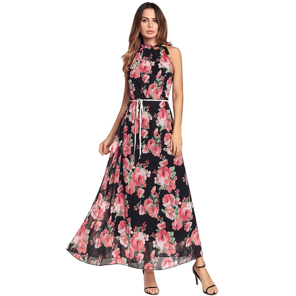 Floral maxi dress, sleeveless, with a fitted waist, model in black and pink design.
