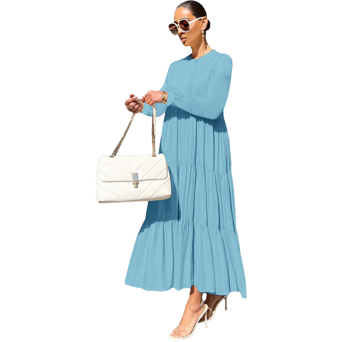 Autumn 2023 women's loose-fit short sleeve casual dress in light blue, styled with a white handbag and sunglasses.