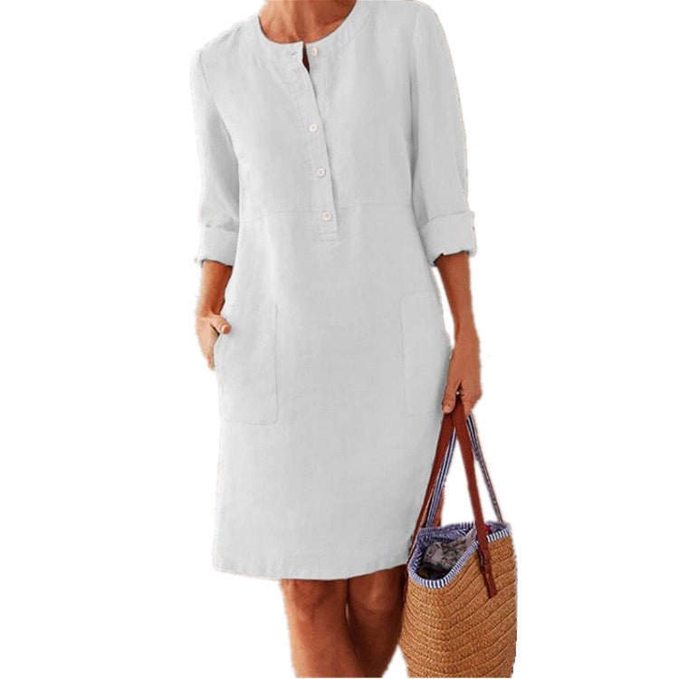 Women's elegant simple cotton summer dress in white, shown with rolled sleeves and a relaxed fit.