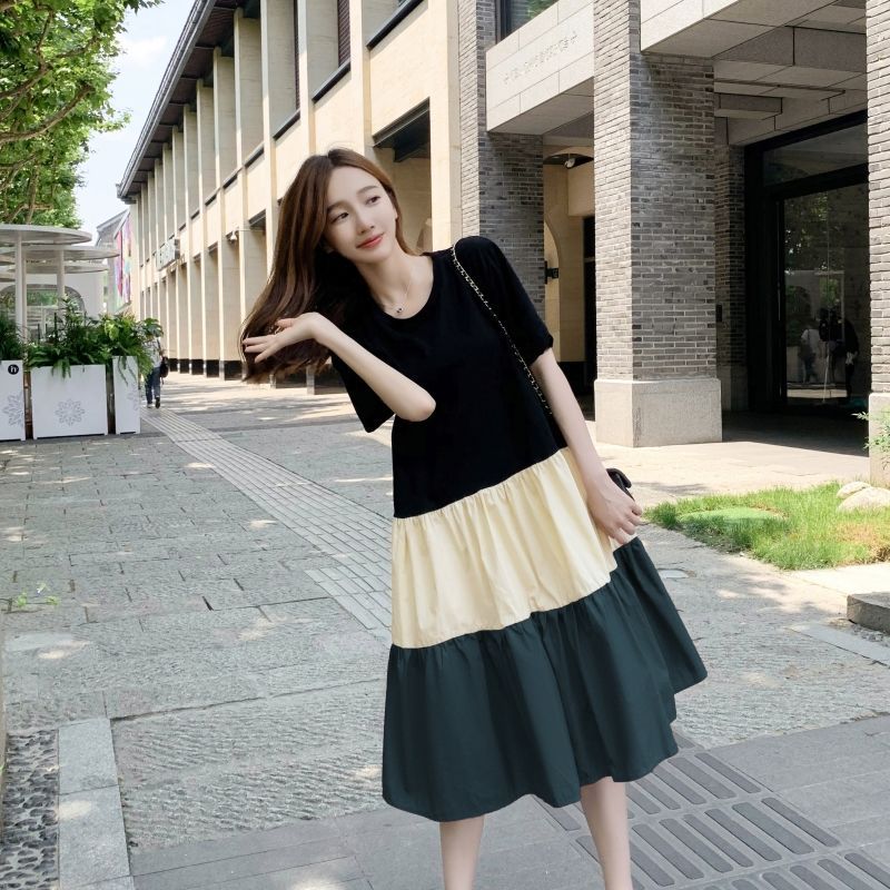 Women's summer Korean style patchwork dress in black, cream, and grey, worn casually outdoors.
