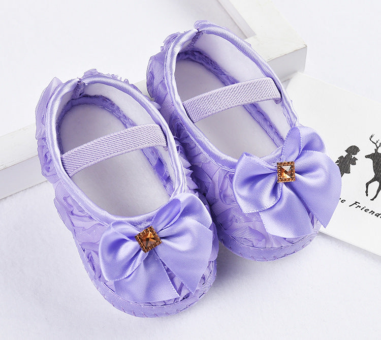 Baby Toddler Princess Shoes in purple silk with bow and anti-slip sole.