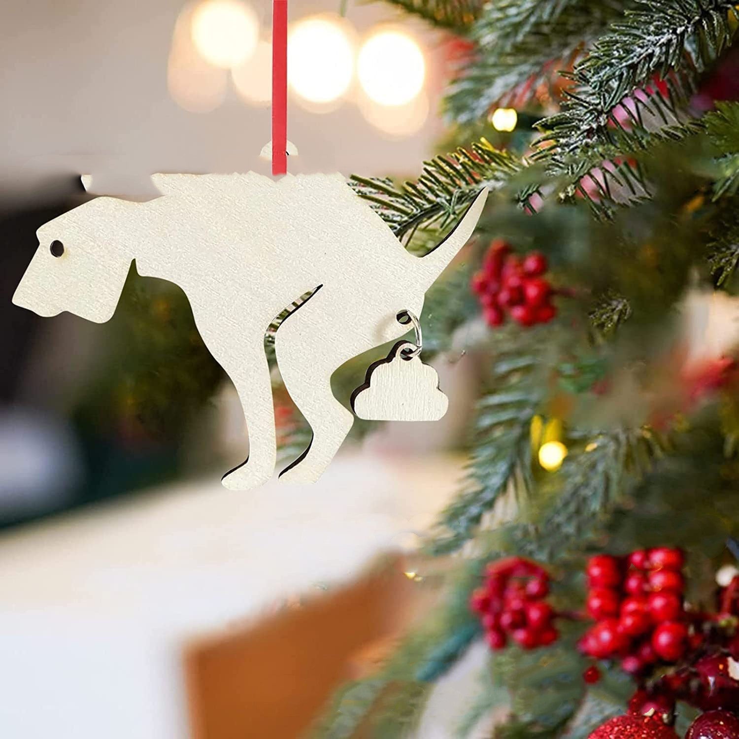 Boxwood decorative Christmas tree pendant in dinosaur shape on a festive tree.