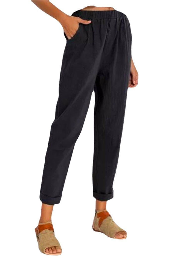 Casual Harem Pants in a dark shade, styled with tan sandals and one hand resting in a side pocket