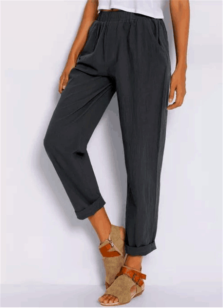 Casual Harem Pants in grey, shown with one knee bent to display the relaxed fit and rolled hems