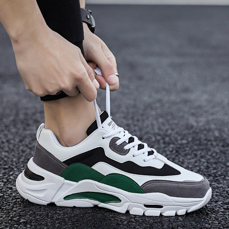 Mens Chunky Platform Sneakers in Green with white, black and grey panels, shown while a person adjusts the laces.